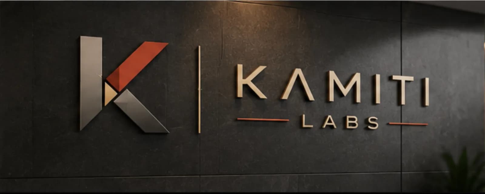 Kamiti Labs brand signage on a dark stone office wall